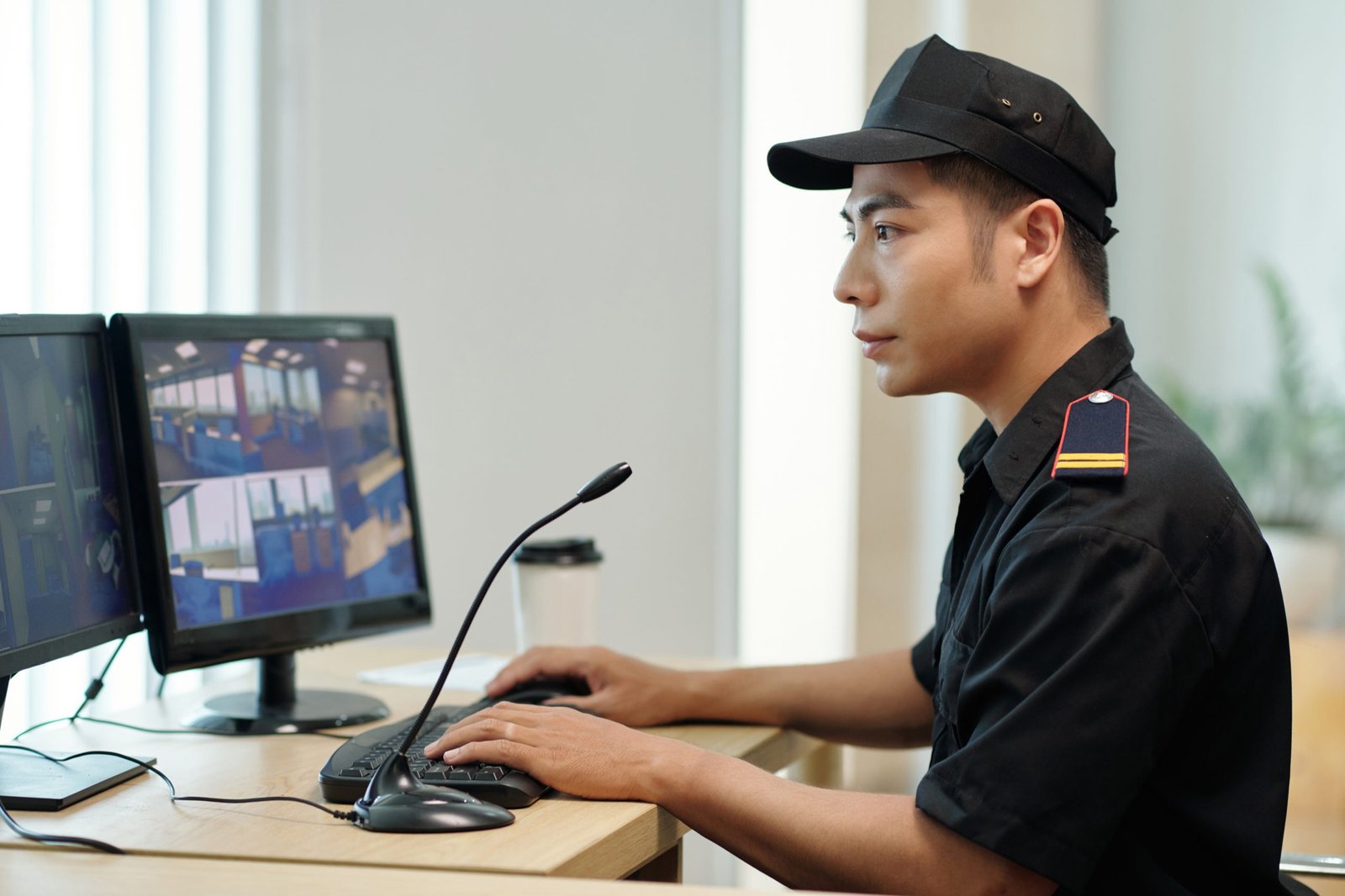 Security guard watching videos on computer screen